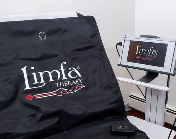 The LIMFA Therapy mat and its control monitor staged in a treatment room at Elevate Wellness Studio
